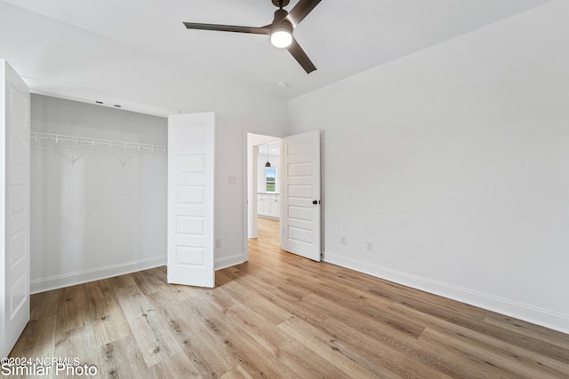 unfurnished bedroom featuring ceiling fan, light wood-type flooring, and a closet