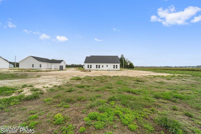 view of yard with a rural view