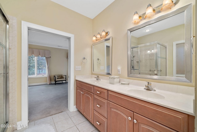 bathroom with tile patterned flooring, vanity, and an enclosed shower