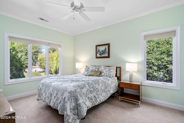 carpeted bedroom featuring ceiling fan and crown molding