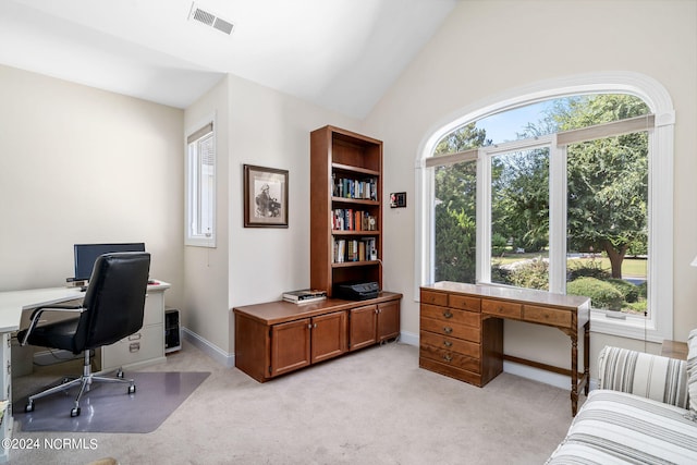 carpeted home office featuring high vaulted ceiling