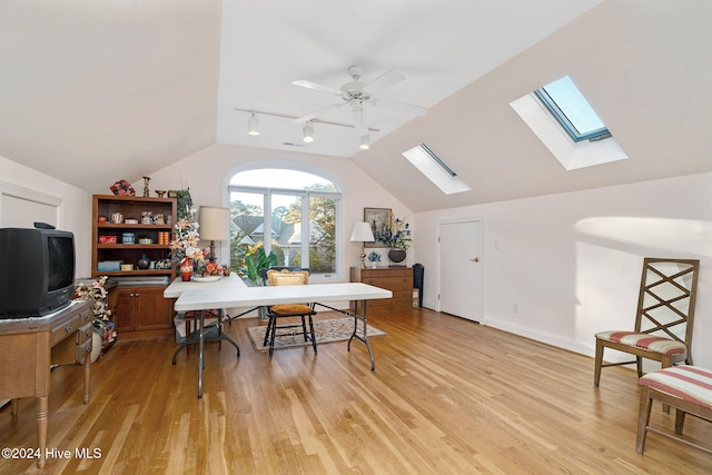 home office featuring rail lighting, light hardwood / wood-style flooring, ceiling fan, and lofted ceiling