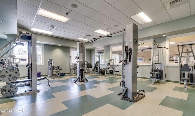 workout area with a paneled ceiling