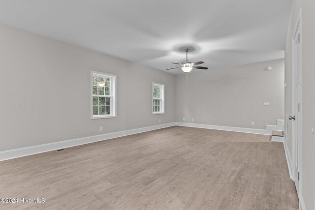 spare room featuring light hardwood / wood-style flooring and ceiling fan