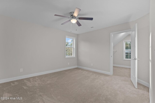 carpeted spare room with ceiling fan