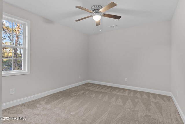 unfurnished room featuring light colored carpet and ceiling fan