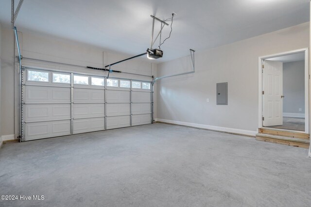 garage with electric panel and a garage door opener