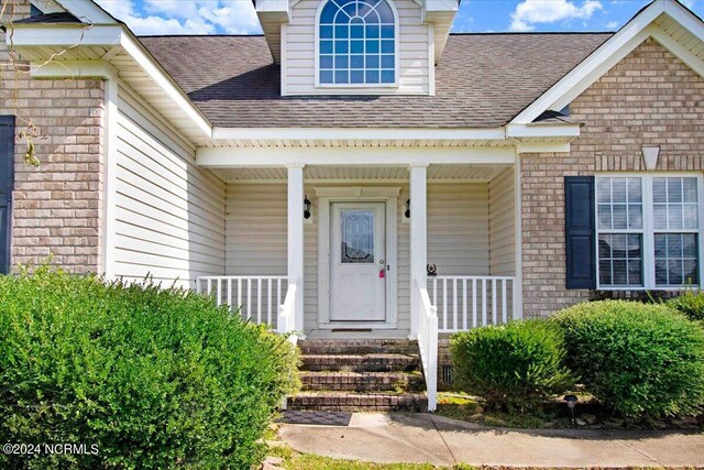 doorway to property with a porch