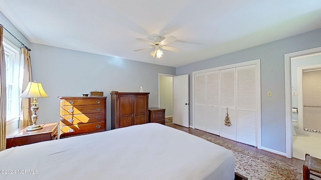 bedroom featuring a closet, ceiling fan, hardwood / wood-style flooring, and connected bathroom