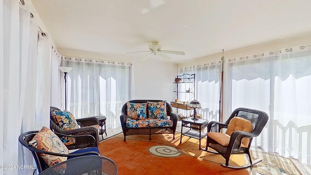 sunroom / solarium featuring ceiling fan