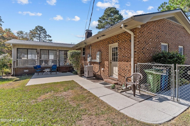 back of house featuring a patio and a lawn