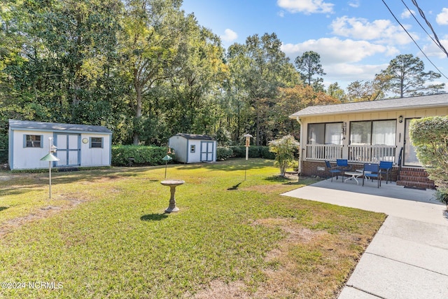 view of yard featuring a shed and a patio