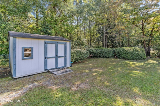 view of outbuilding featuring a lawn