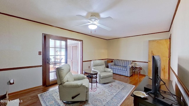 sitting room featuring ornamental molding, hardwood / wood-style flooring, and ceiling fan