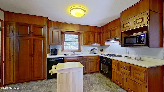 kitchen featuring a center island, black appliances, and sink