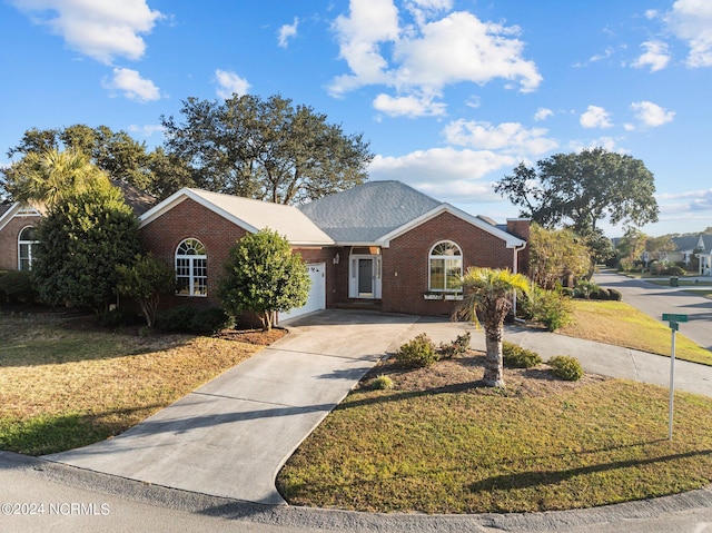 single story home featuring a front yard and a garage