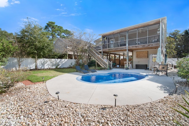 view of pool featuring a sunroom and a patio area