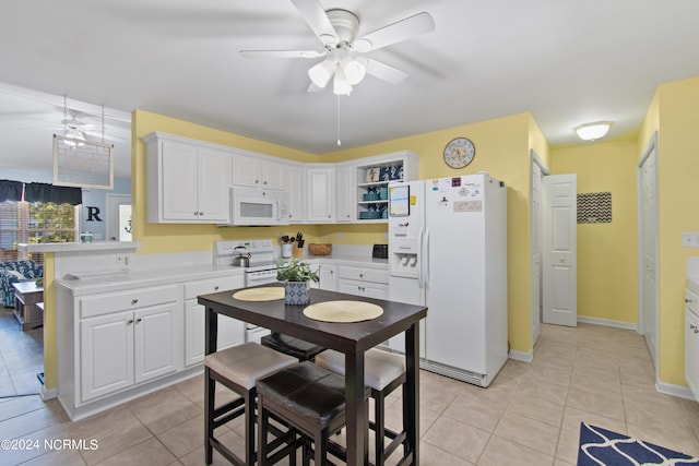 kitchen with white cabinets, white appliances, kitchen peninsula, and light tile patterned flooring