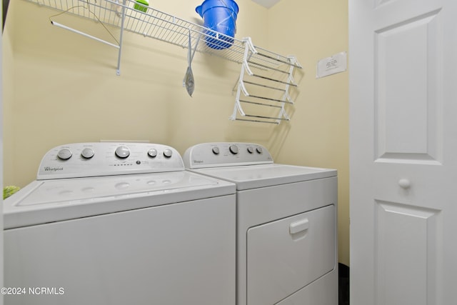 clothes washing area featuring washer and clothes dryer