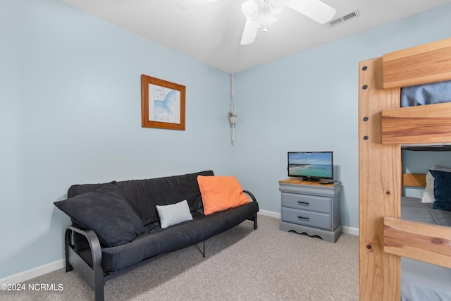 carpeted living room with ceiling fan