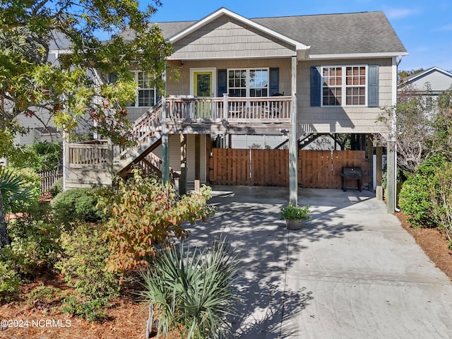 view of front of property featuring a carport and a porch