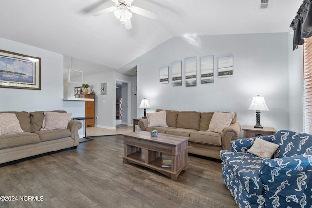 living room with lofted ceiling, ceiling fan, and dark wood-type flooring