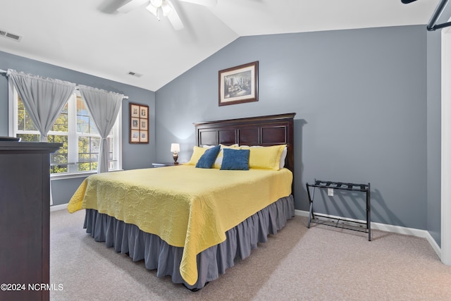 bedroom featuring light carpet, lofted ceiling, and ceiling fan