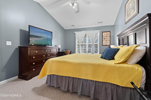 bedroom with vaulted ceiling, ceiling fan, and light colored carpet