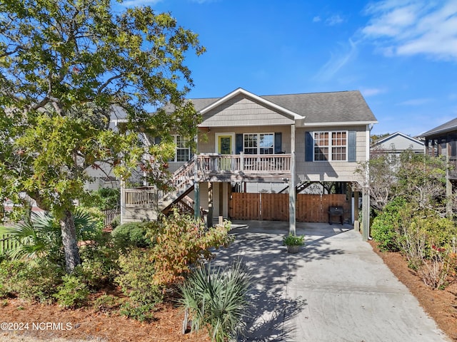 view of front of house featuring covered porch and a carport