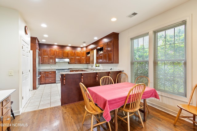 dining room with light hardwood / wood-style floors and sink