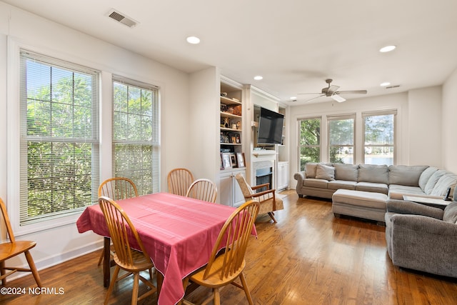 dining room featuring ceiling fan, hardwood / wood-style flooring, and plenty of natural light