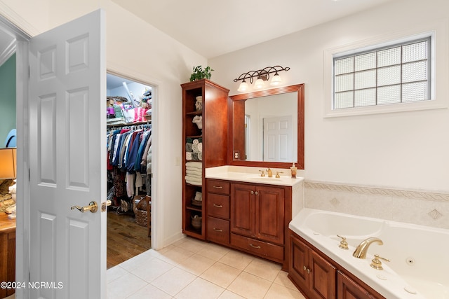 bathroom with vanity, a tub to relax in, and tile patterned floors