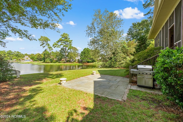 view of yard featuring a patio area and a water view