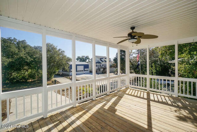 unfurnished sunroom with ceiling fan