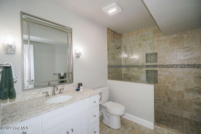 bathroom featuring vanity, toilet, and a walk in shower