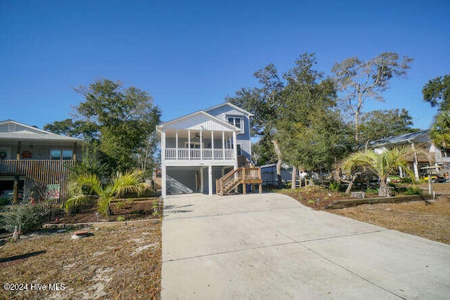 beach home featuring a porch and a garage