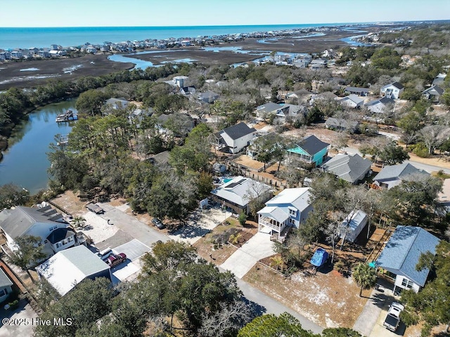 birds eye view of property featuring a water view and a residential view