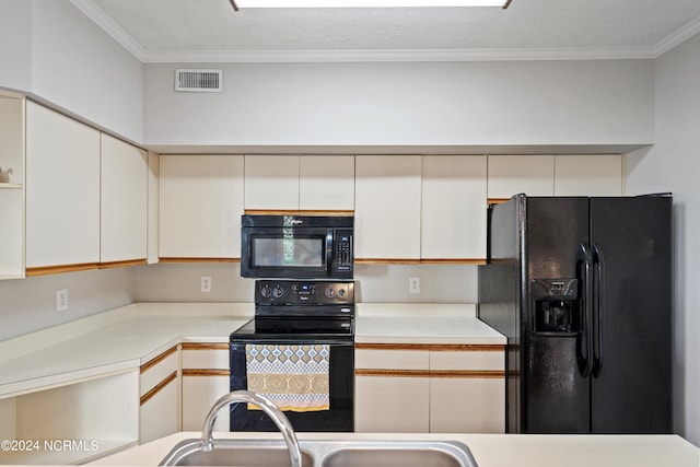 kitchen featuring ornamental molding, light countertops, visible vents, and black appliances