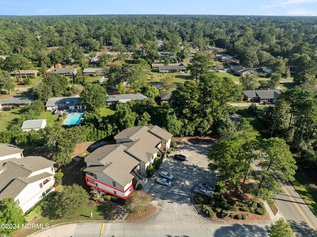 birds eye view of property with a residential view and a view of trees