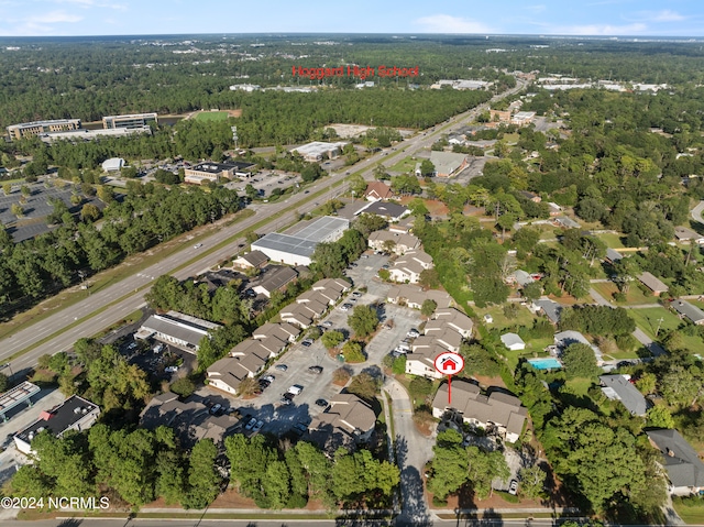 drone / aerial view with a wooded view