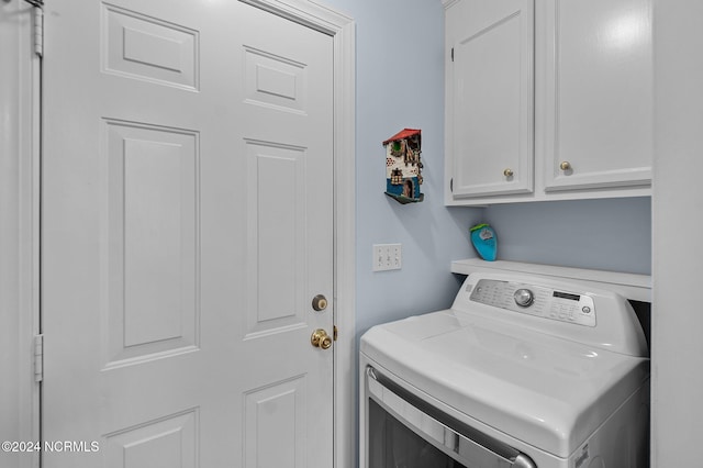 washroom featuring washer / clothes dryer and cabinets