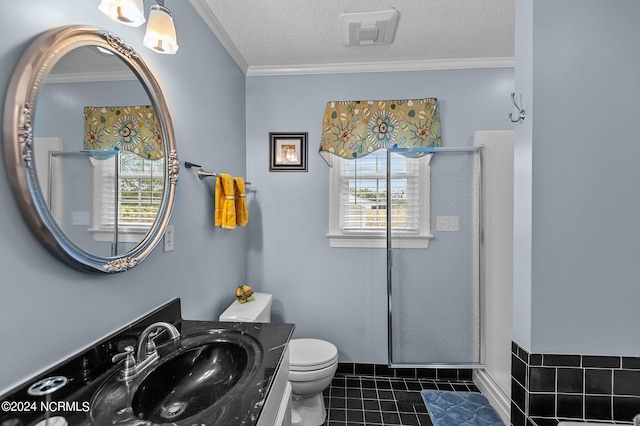 bathroom featuring a shower with door, crown molding, vanity, and toilet