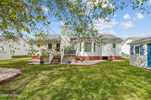 back of house with a yard and a deck