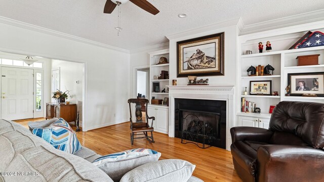 kitchen featuring black appliances, sink, light hardwood / wood-style floors, and a textured ceiling