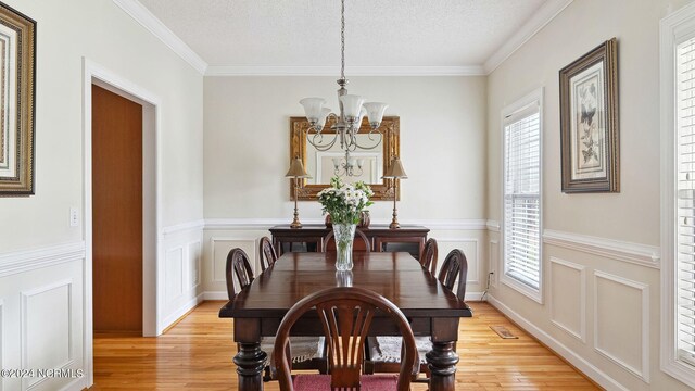 office featuring ceiling fan, light hardwood / wood-style floors, and a healthy amount of sunlight