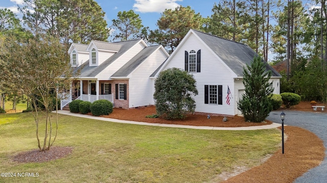 cape cod-style house with a front yard