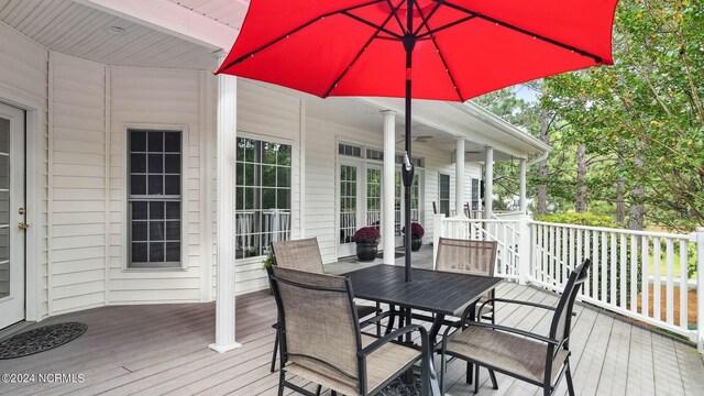 back of property with a wooden deck and ceiling fan