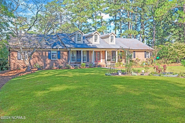 cape cod home with a porch and a front yard