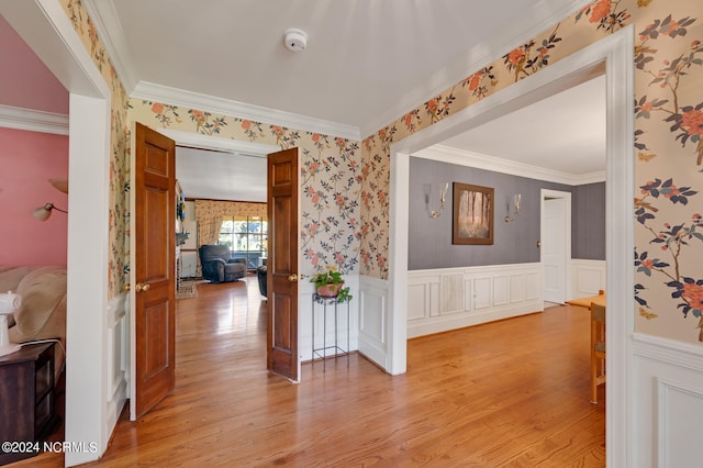 hallway featuring light wood-type flooring and crown molding