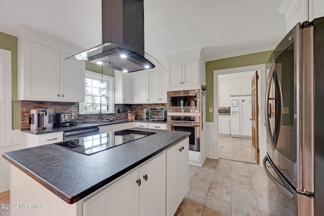 kitchen with decorative backsplash, island range hood, stainless steel appliances, white cabinets, and a center island